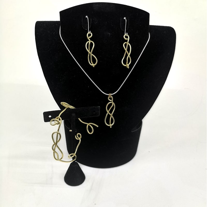 A full sterling silver jewellery set on a mannequin torso including earrings, necklace and broach.
